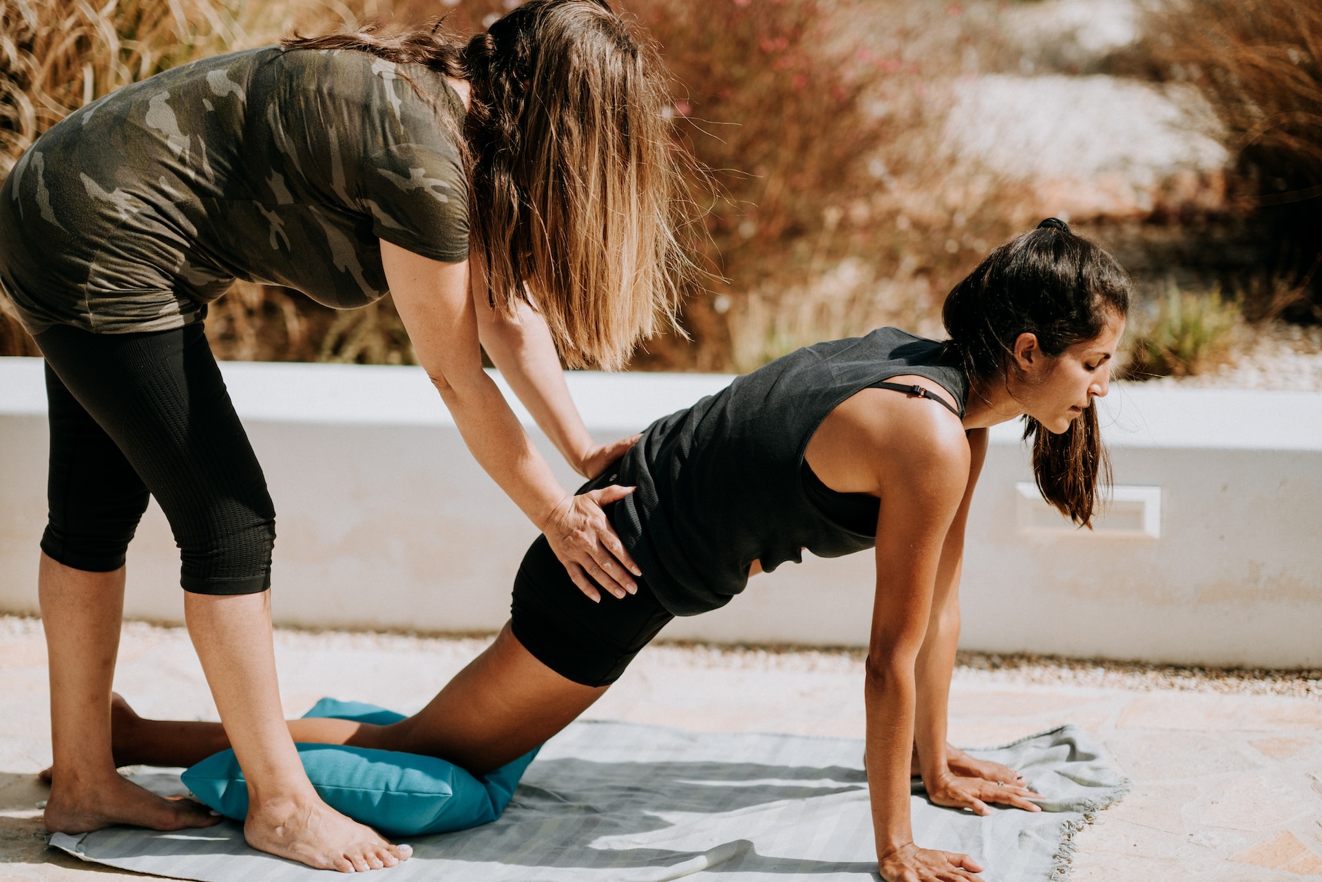 the image shows two women on a stretching class
