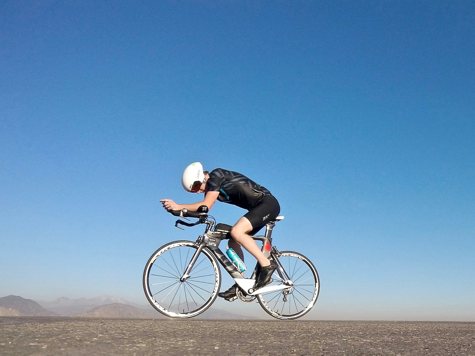 this image shows a male athlete doing bicycling triathlon