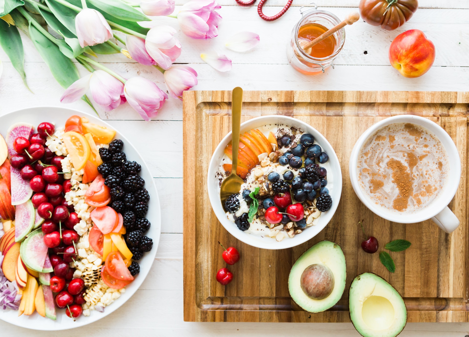 the image shows a healthy breakfast with fruits and berries