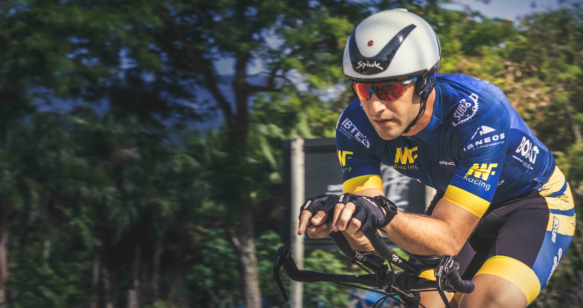 the image shows an athlete doing a cycling triathlon