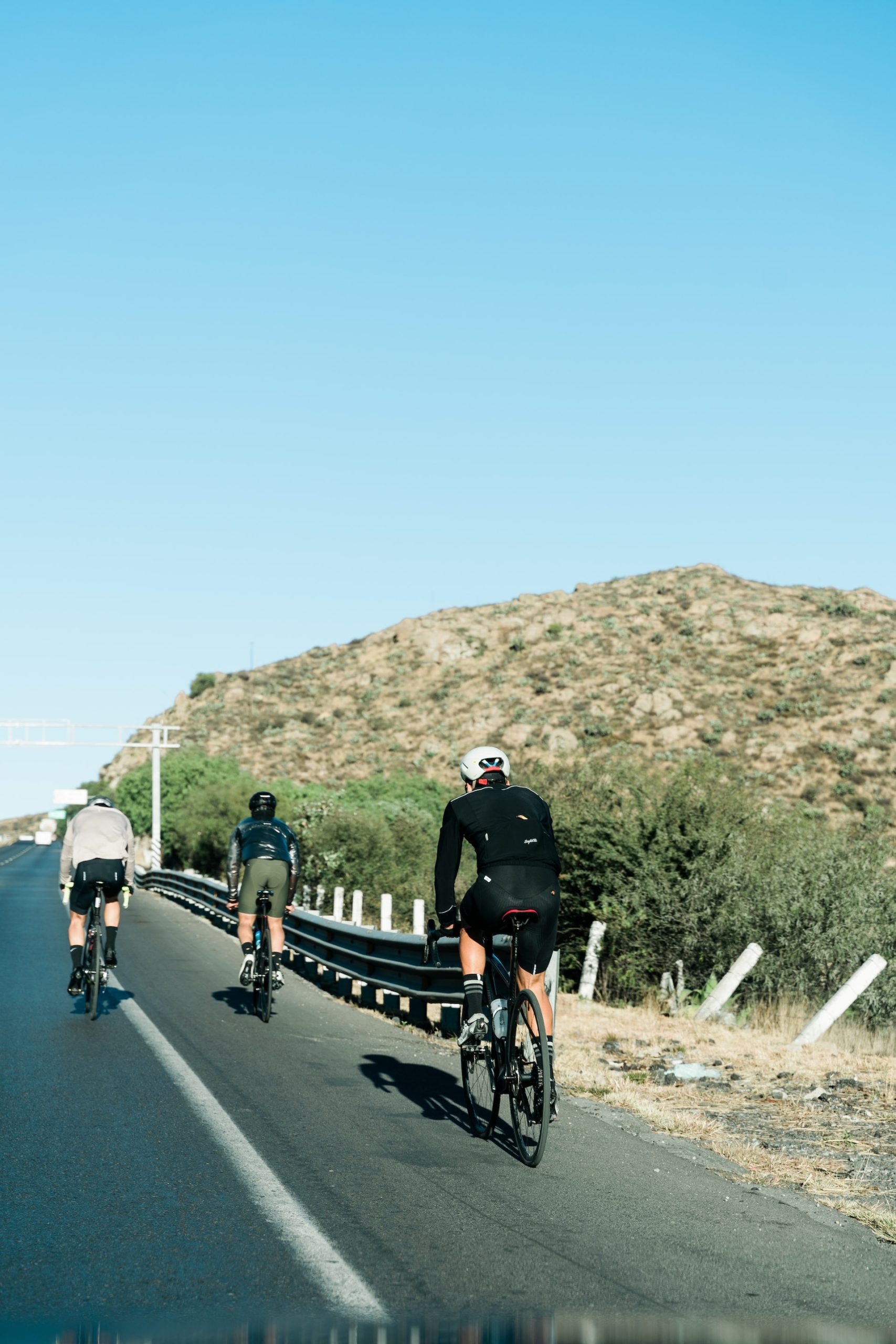 Three athletes doing bicycling triathlon