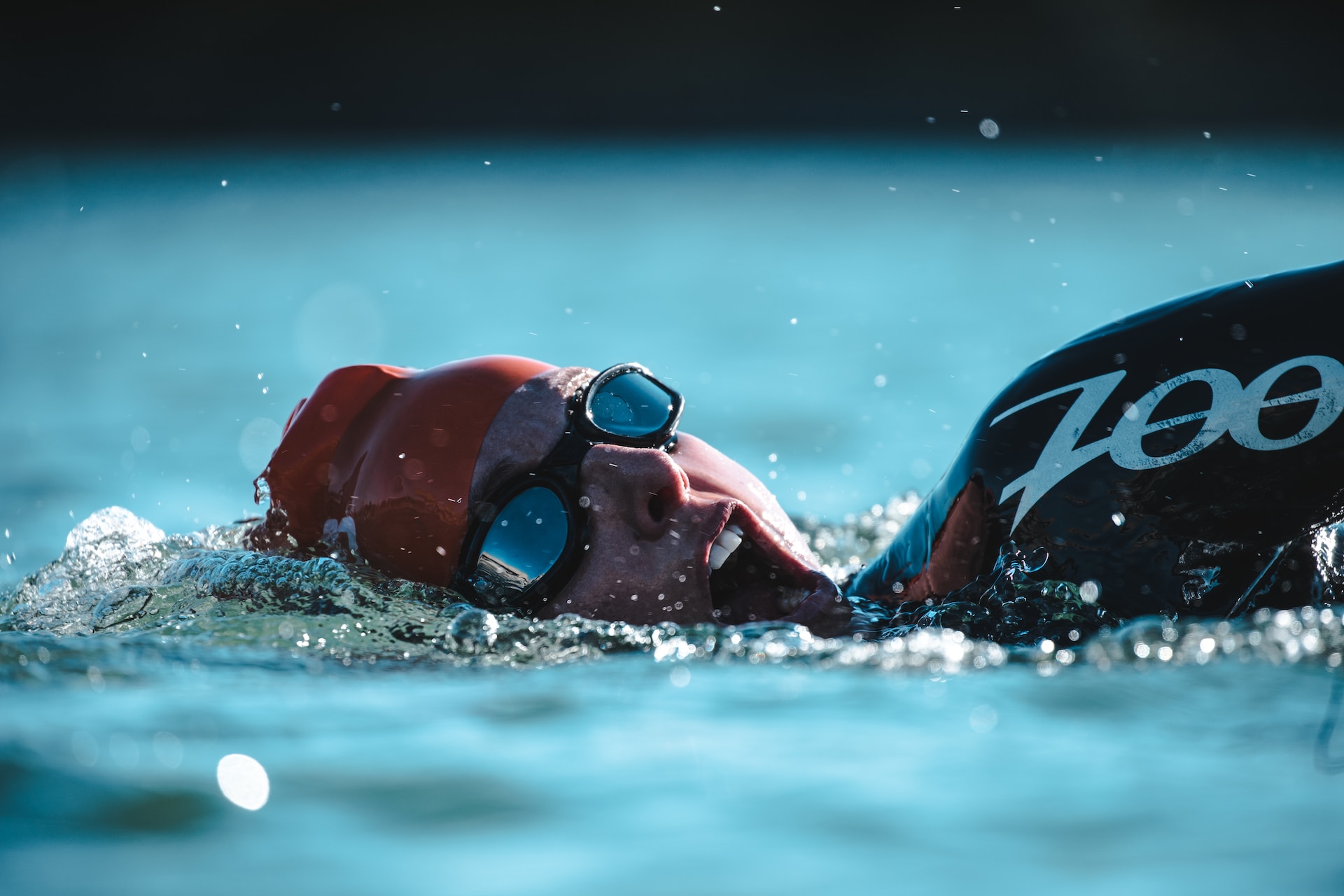 the image shows an athlete swimming at the race
