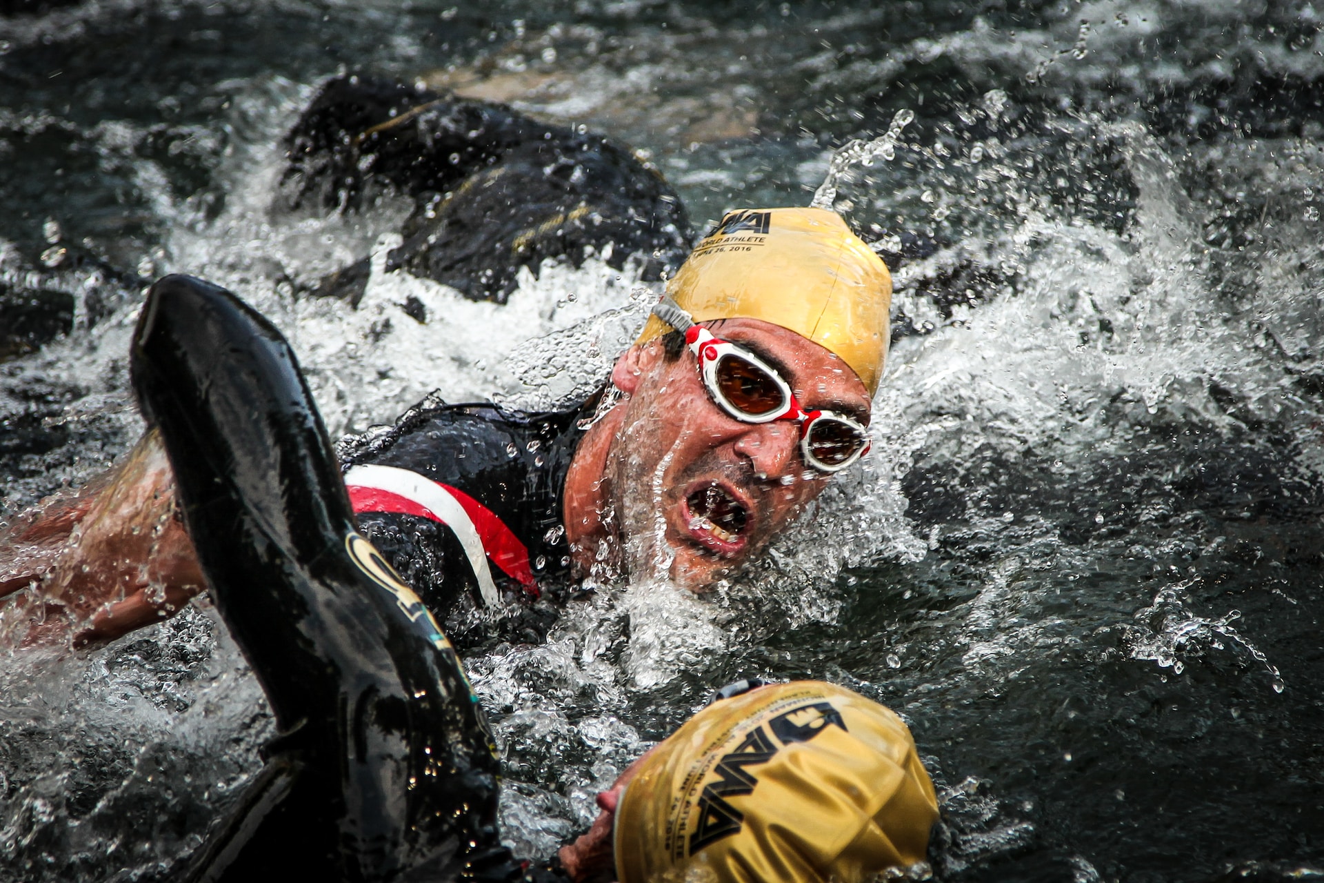 Two male athletes swimming during one of types of ironman