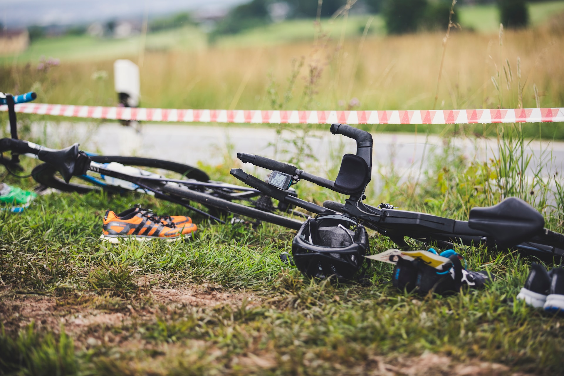 the image shows a bicyclist's equipment laying on the grass
