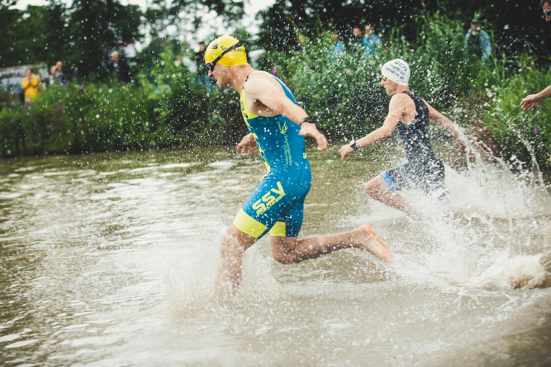 Two athletes running to dive into the water