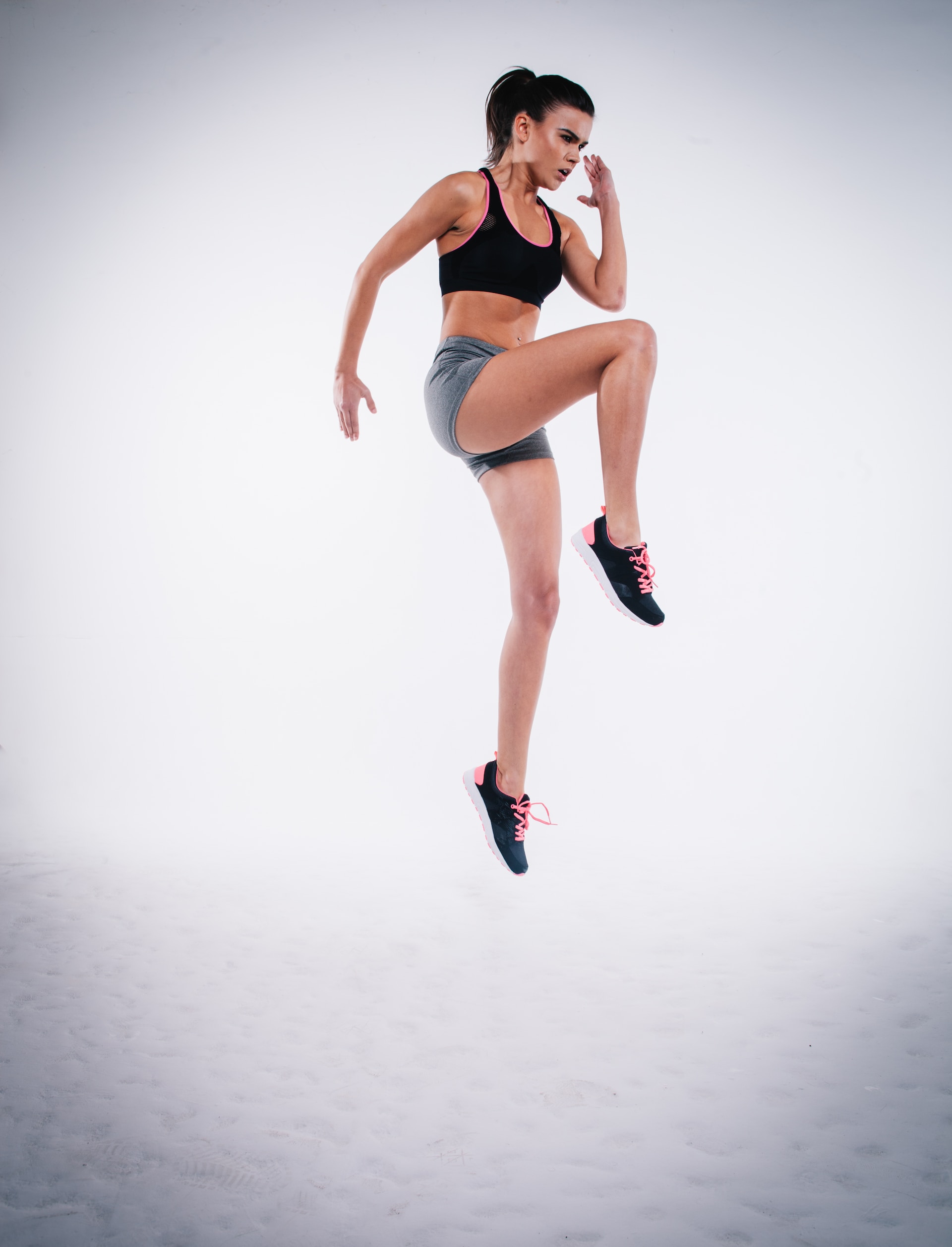 the image shows a female athlete in a jump