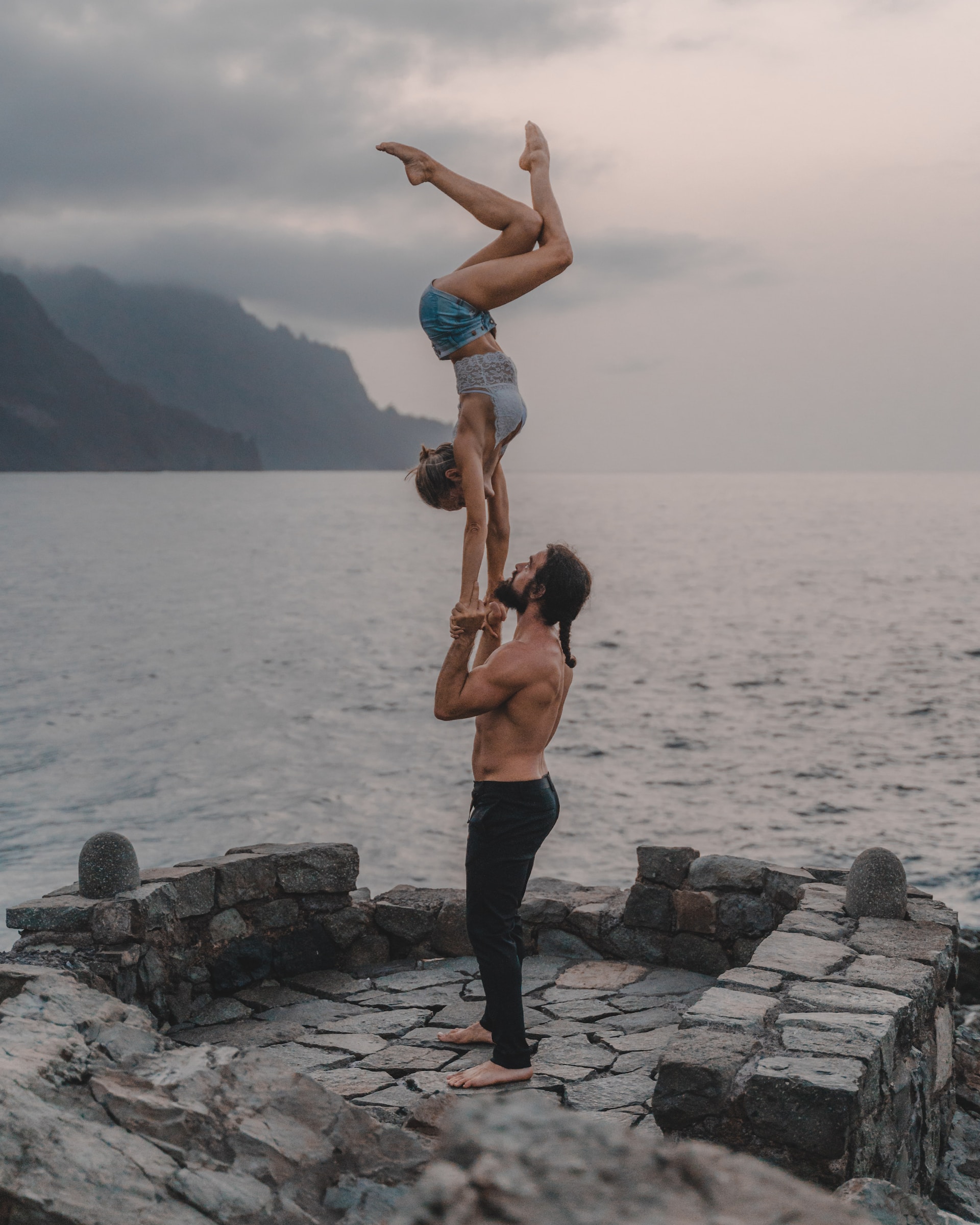 the image shows a female and a male athlete doing gymnastics 