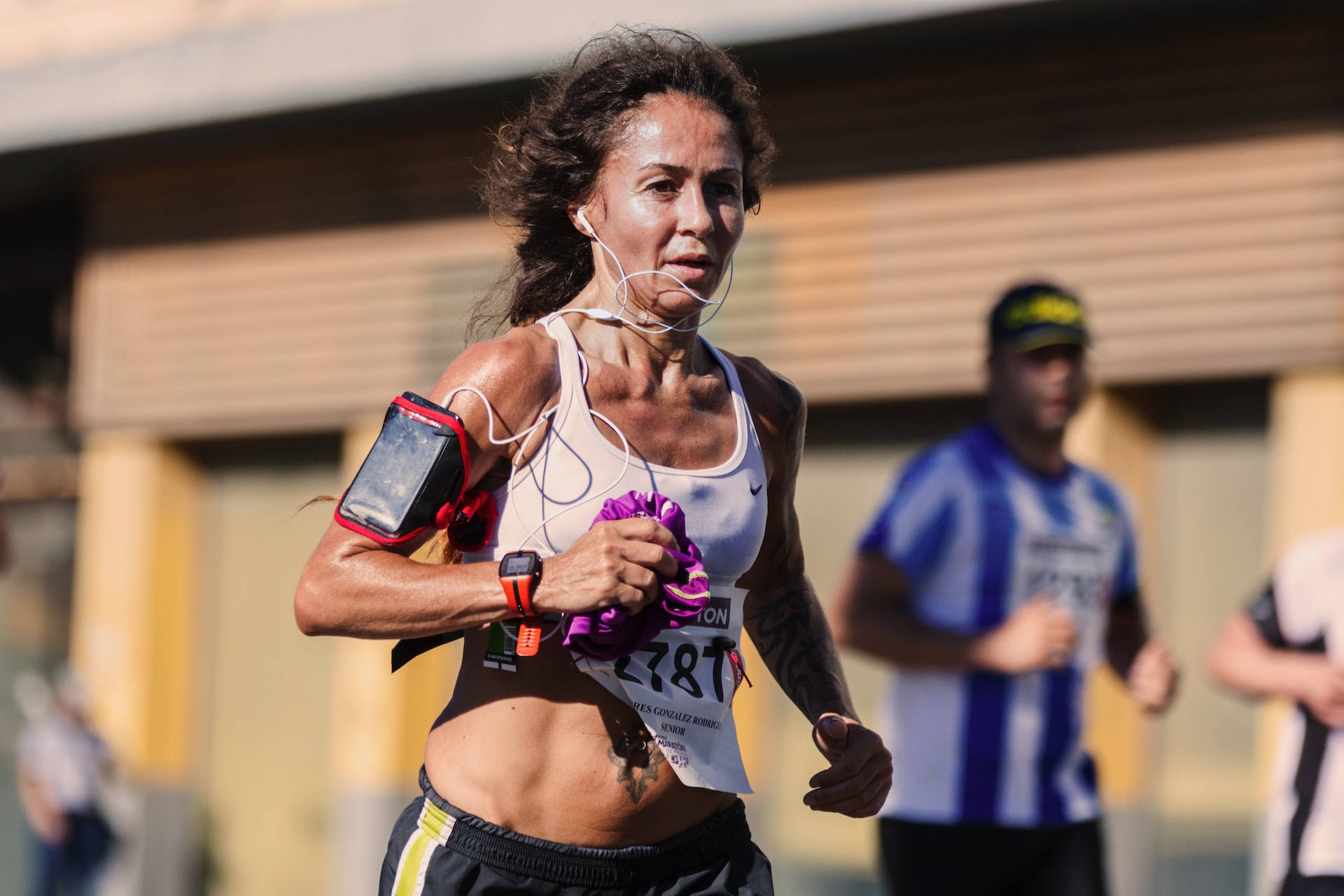 the image shows a woman running on the triathlon marathon