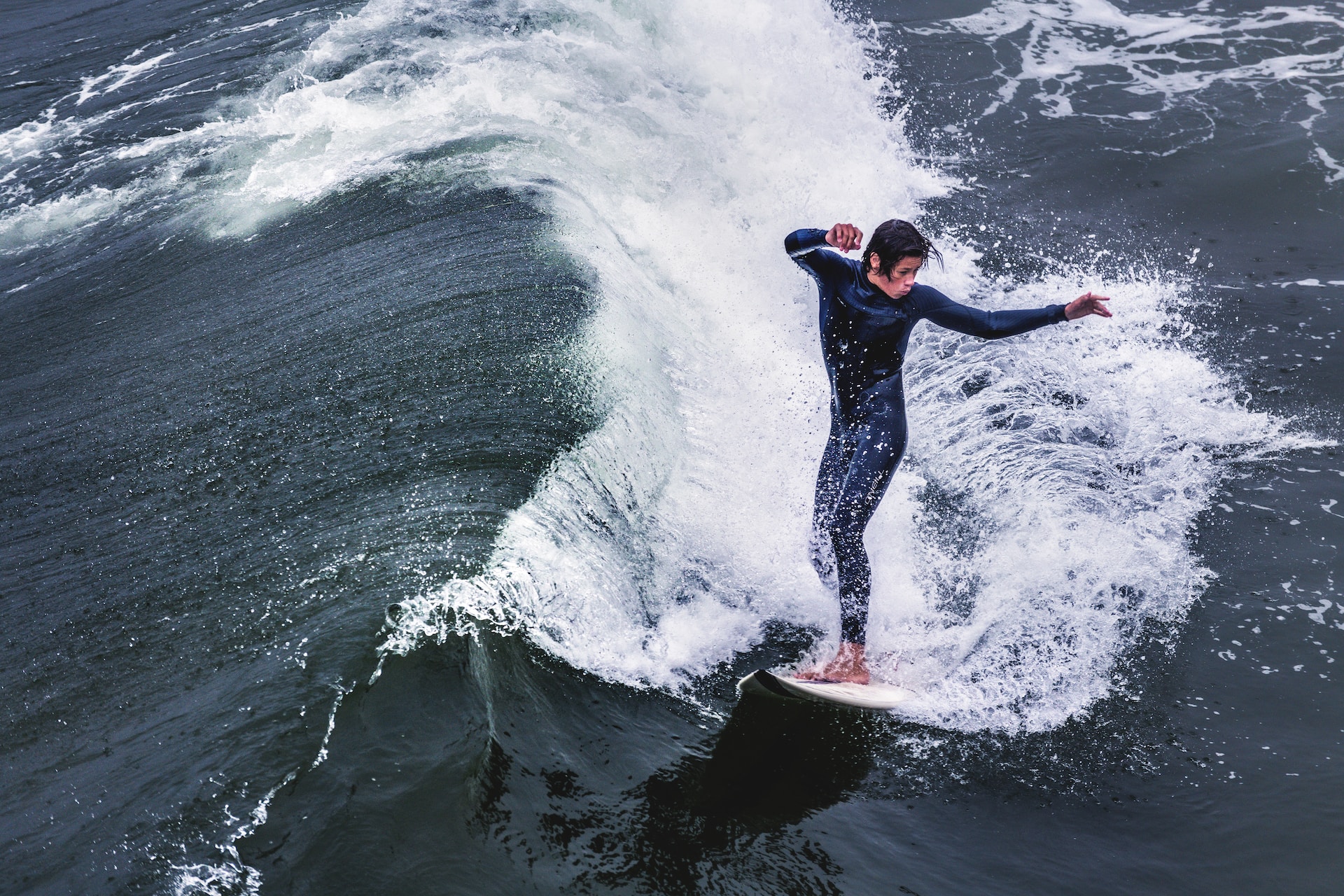 the image shows a male surfer on the wave 