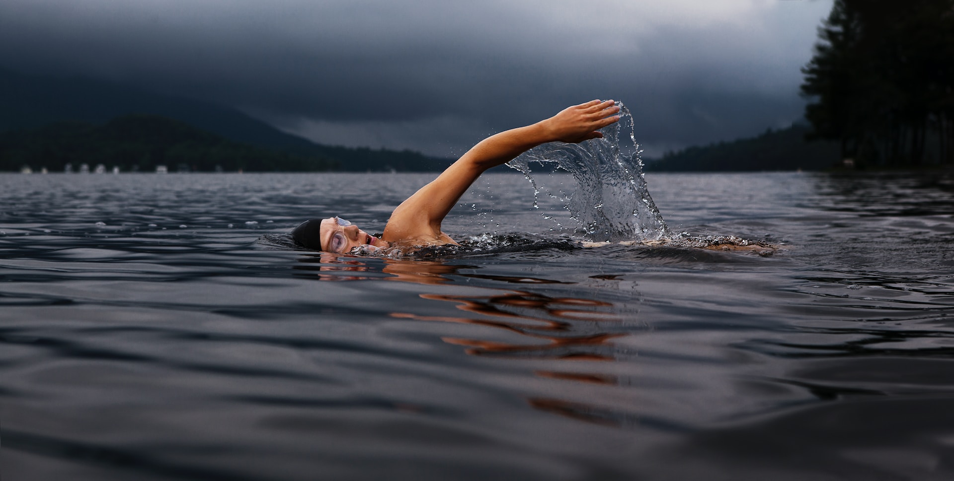 the image shows a professional female athlete swimming