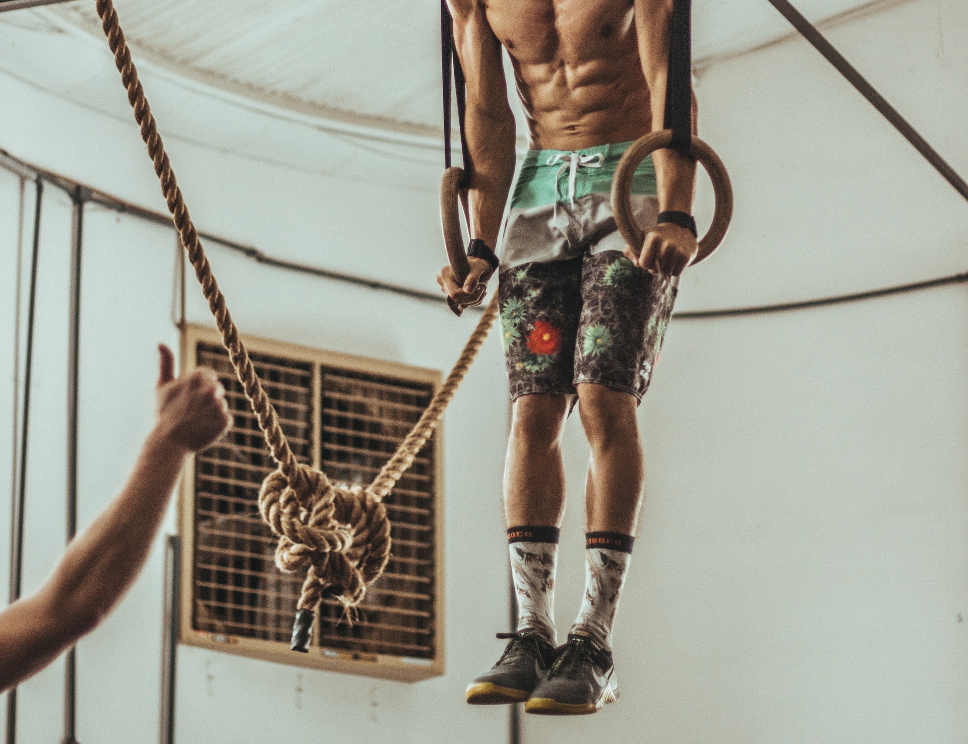 the image shows a sportsman pulling up on the ropes