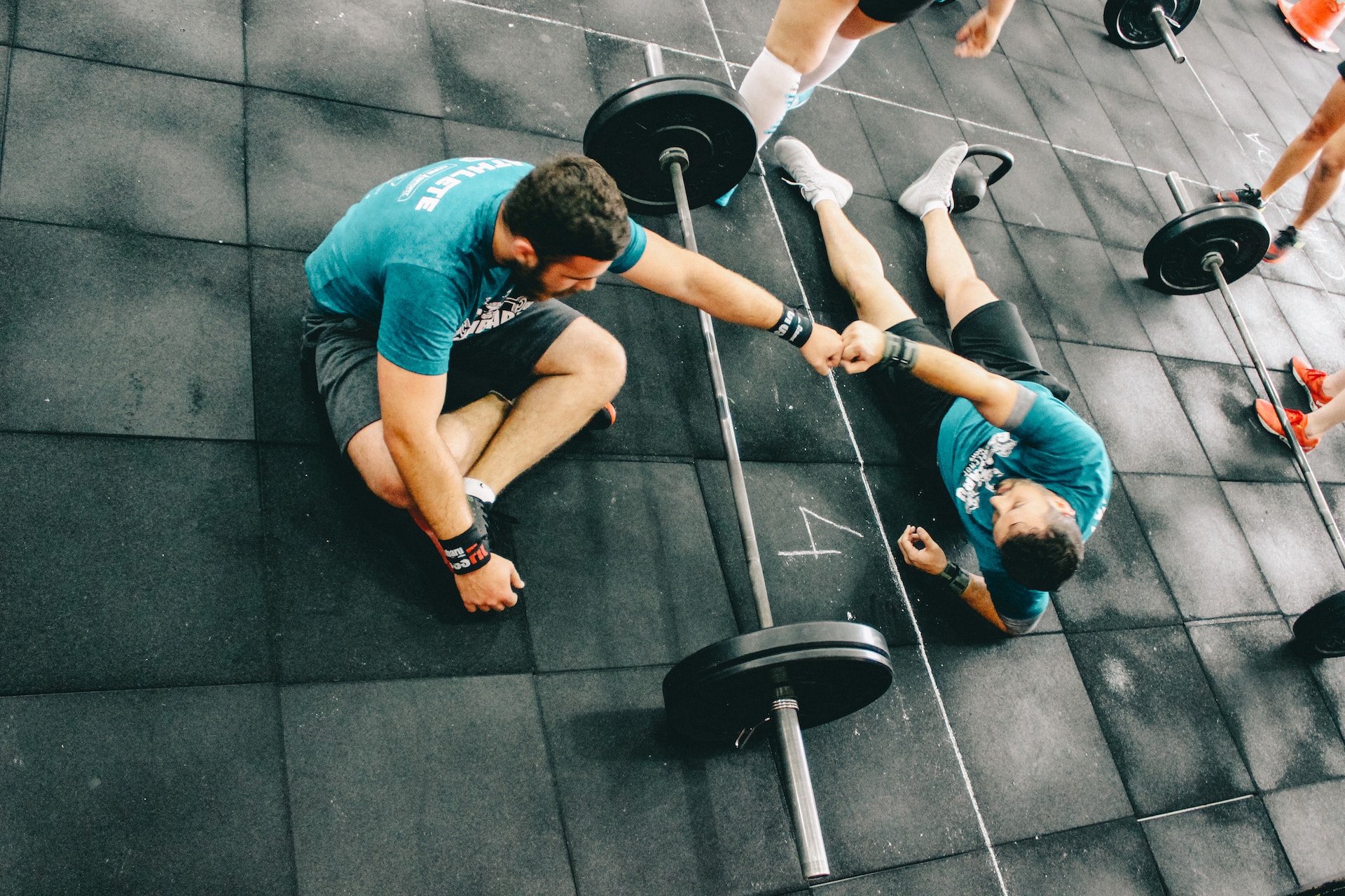 the image shows two men in the gym