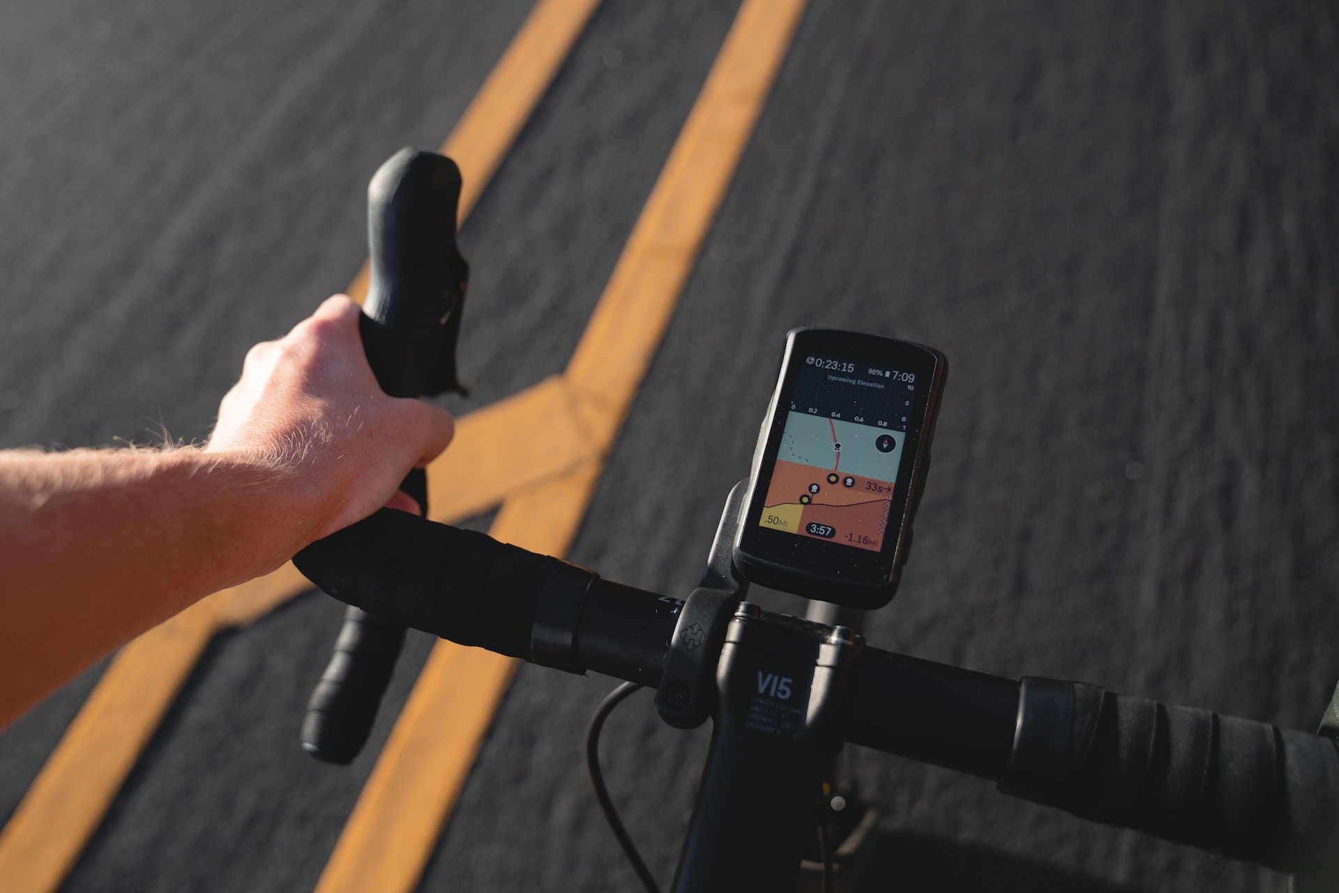 the image shows a fitness watch on the bicycle handlebars